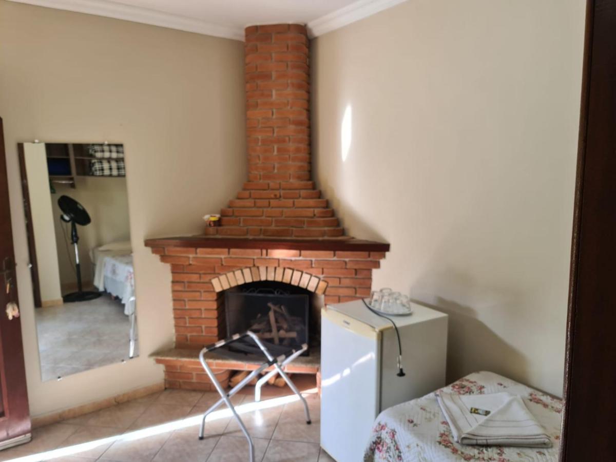 Pousada Nossa Senhora Penedo  Exterior photo A fireplace in a guest room at the hotel